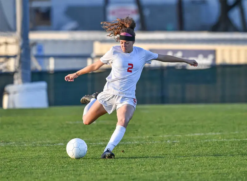 A soccer player about to kick the ball