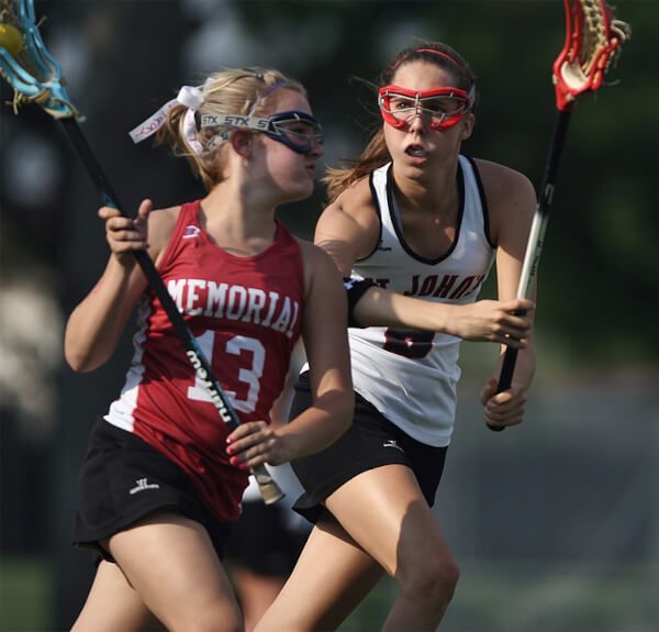 Two lacrosse players playing lacrosse